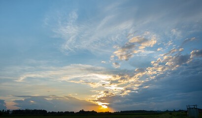 Wall Mural - Colorful sunset and sunrise with clouds. Blue and orange color of nature. Many white clouds in the blue sky. The weather is clear today. sunset in the clouds. The sky is twilight.