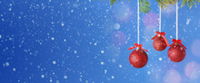 Beautiful Christmas Balls Hanging On Coniferous Branch Against Blue Background