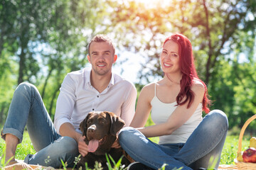 Canvas Print - Couple with a dog in the park