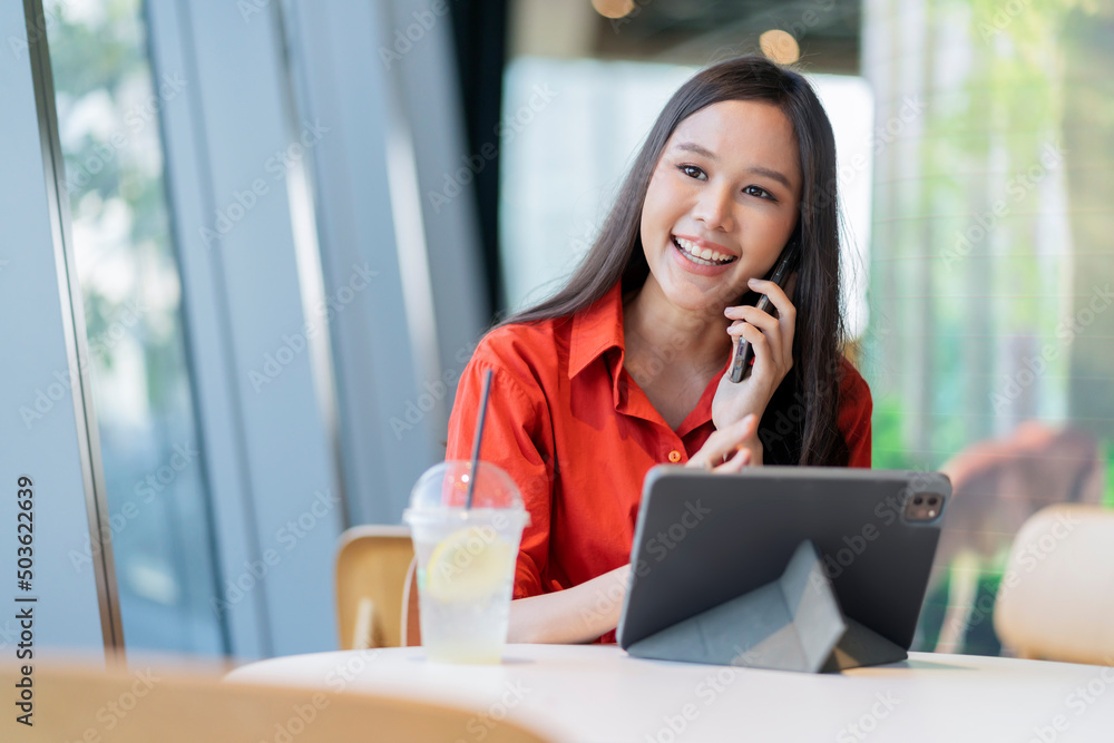 relax leisure attractive smart asian female freelance entrepreneur smile and enjoy working with smartphone and laptop at cafe with blur city business digital nomad casual ideas concept