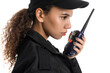 African-American female security guard with radio transmitter on white background