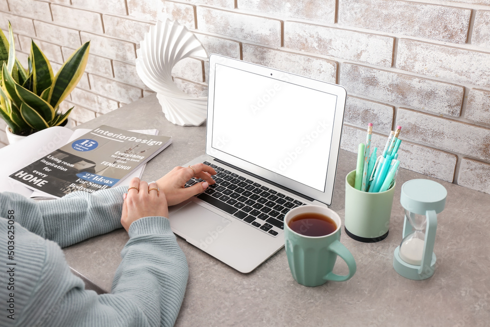 Woman working with modern laptop on table, closeup