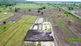 Fototapeta Mapy - Aerial drone view of green fields and farmland.