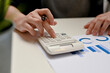 © bongkarn - Female accountant working on her accounting sale report