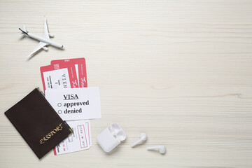 Sticker - Flat lay composition with passport, toy plane and tickets on white wooden background, space for text. Visa receiving