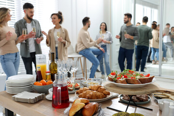 Sticker - Brunch table setting with different delicious food.and blurred view of people on background