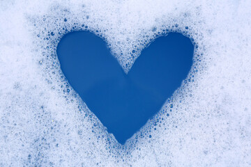 Poster - Heart shape made of detergent foam in water, top view. Hand washing laundry