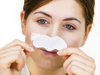 Wall Mural - Woman applying pore strips on nose