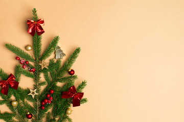 Christmas concept with green branches of fir tree with red christmas decoration