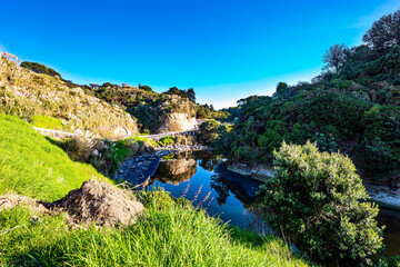 Wall Mural - The Vaipingau Stream reflects hills