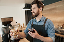Smiling Barista At Bar Counter With With Brewed Filtered Coffee. High Quality Photo