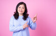 © Timeimage - Portrait of middle aged Asian woman on pink background