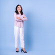 © Timeimage - Full length image of middle aged Asian woman on blue background