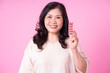 © Timeimage - Image of middle aged Asian woman on pink background