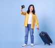 © Timeimage - Full length image of middle aged Asian woman on background, summer concept