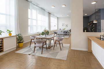 dinnig and kitchen area in minimalist modern interior design huge bright apartment with an open plan in Scandinavian style in white, blue and dark blue colors with columns in the center