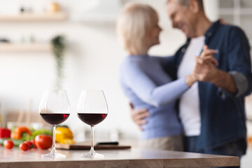 Two glasses of red wine on kitchen table