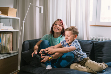 Wall Mural - mother and son playing video games at home