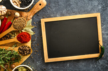 Canvas Print - Food menu concept. Chalkboard with spices and herbs top view with rice, various beans on dark background