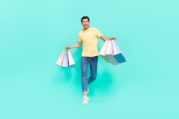 Sticker - Full size photo of nice brunet guy run with bag wear t-shirt jeans shoes isolated on teal background