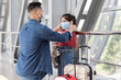 © Prostock-studio - Dad Putting Mask To Little Daughter While They Standing At Airport Terminal