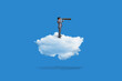 business man standing on clouds and using telescope on blue background, business concept