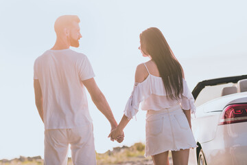 Poster - Photo of carefree sweet husband wife wear casual clothes riding cabriolet holding arms outside countryside