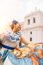 Vertical Photo Of A Latin Woman In A Traditional Dress From Nicaragua Dancing In Front Of A Colonial Church. Concept Of Culture And Traditions Of Latin America.