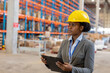 © Wavebreak Media - African american young female manager holding clipboard looking away while working in warehouse