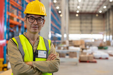 Portrait Of Confident Asian Mature Male Worker With Arms Crossed Wearing Reflective Vest And Helmet