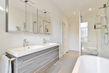 Contemporary Bathroom With Shower Cabin Bathtub And Sinks In Sunlight