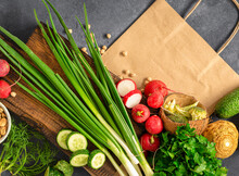 Paper Bag With Fresh Food For Cooking Healthy Food. Fresh Vegetables, Herbs, Cereal And Nuts On Dark Background Top View, Grocery. Food Purchase Concept
