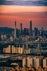 Vertical shot of Guangzhou cityscape with Canton Tower at sunset. China.