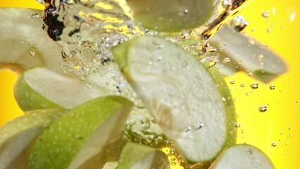 Poster - Super slow motion of rotating sliced green apples pieces underwater. Filmed on high speed cinema camera, 1000 fps.