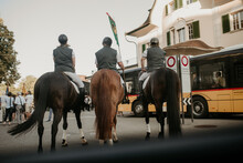 Beautiful Shot Of Three Horse Riders With Horses In A City