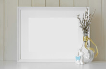 Empty Picture Frame With Beautiful Easter Composition. Modern Glass Vase With Willow Branches, Ceramic Bunny. Wooden Wall Background. Elegant Scandinavian Interior. Spring Easter Still Life Photo