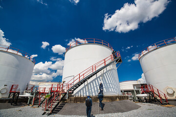 Male worker industry visual inspection storage tank.