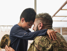 Military Soldier Man Hugging His Son At Home - Father And Child Love