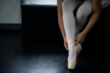 Professional Female Ballerina Wears Her Ballet Shoes To Practice Choreography.