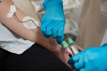 Young woman in blood transfusion concept hand.