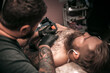 © Mr. Prof - Tattoo specialist working tattooing in tattoo parlor
