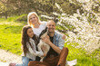 © Angelov - family in a blooming spring garden. Concept of happy family