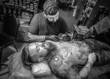 © Mr. Prof - Tattoo specialist showing process of making a tattoo in tattoo parlour