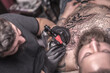© Mr. Prof - Tattoo master makes cool tattoo in tattoo studio