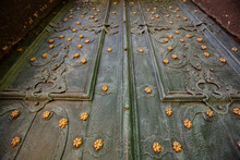 Closeup Of Acient Green Forged Doors With Golden Stars, Tectured Background. Dominican Church In Lviv