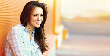 Wall Mural - Summer portrait of beautiful young brunette woman in the city