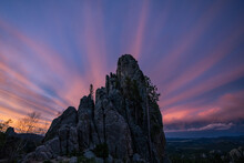 Colorful Clouds Streak Behind A Massive Tower In The Black Hills