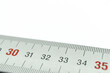 © Иван Решетников - Iron ruler close-up on a white background. Stainless steel ruler. Working tools made of metal and stationery. Selective focus, isolated on white