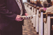 Man passing the offering plate in a traditional American church