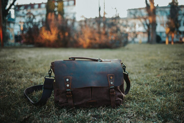 Brown retro leather bag on the grass